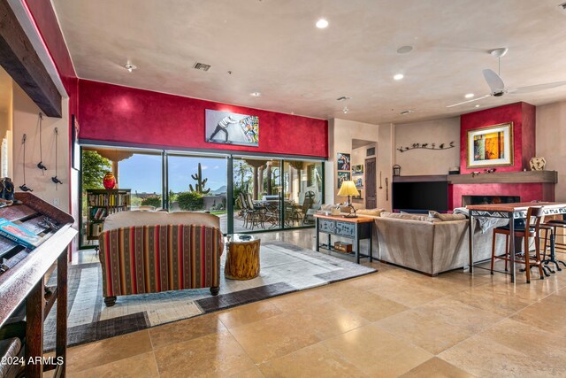 living room with ceiling fan and light tile patterned floors