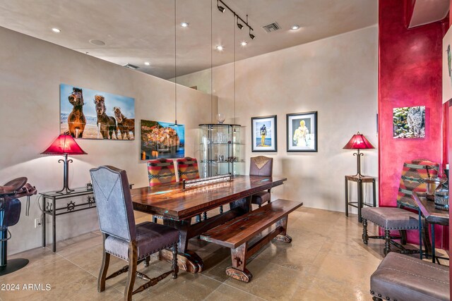 tiled dining room with rail lighting