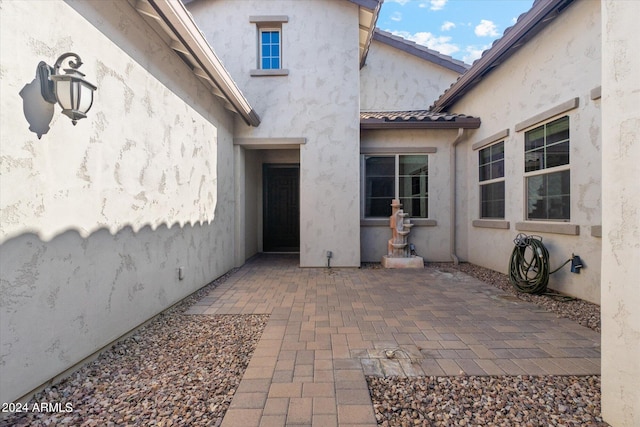 entrance to property featuring a patio area