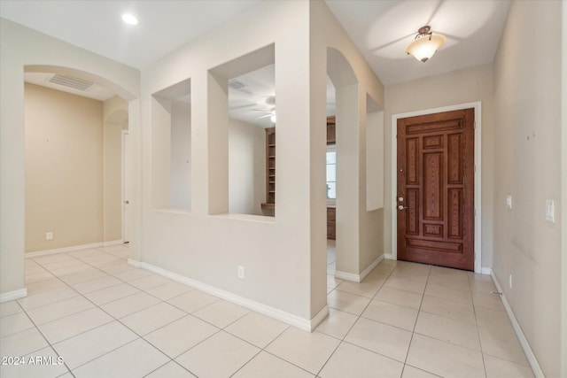 tiled foyer entrance featuring ceiling fan