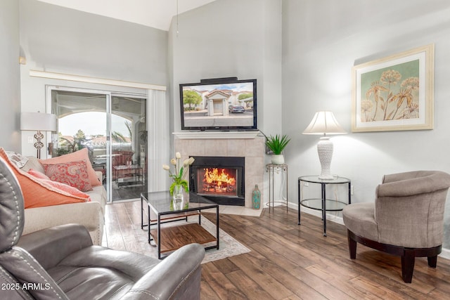 living room featuring a tile fireplace and hardwood / wood-style floors