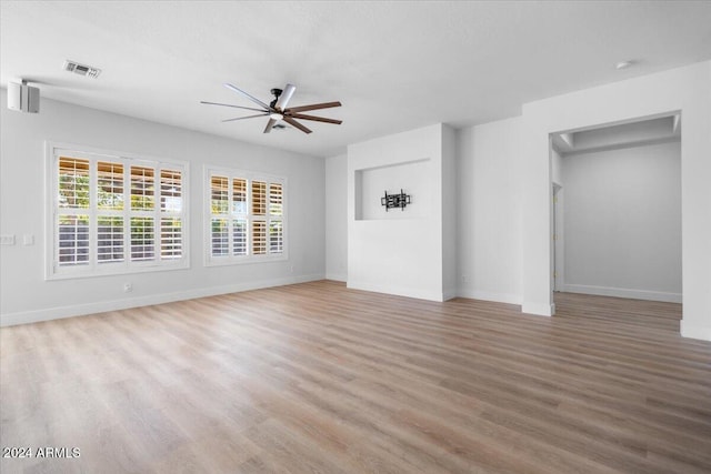 unfurnished living room with light wood-type flooring and ceiling fan