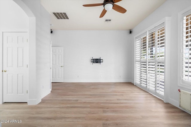 empty room with ceiling fan and light wood-type flooring