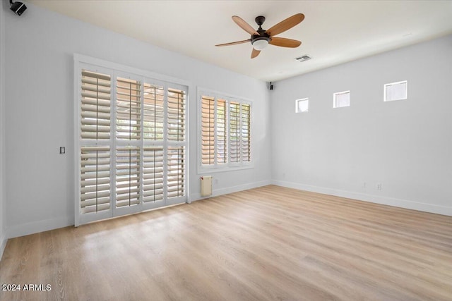 spare room featuring ceiling fan and light hardwood / wood-style floors