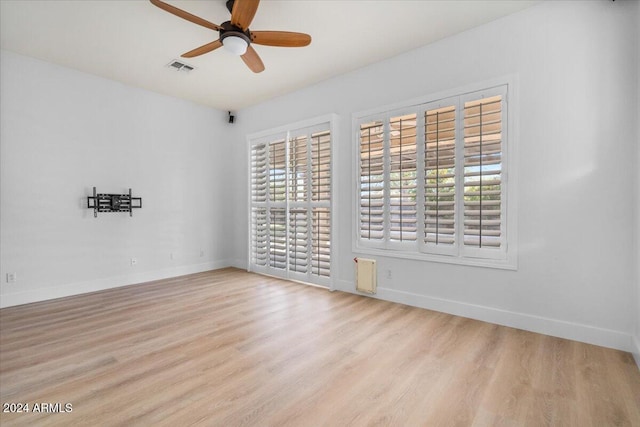 spare room with ceiling fan and light hardwood / wood-style floors