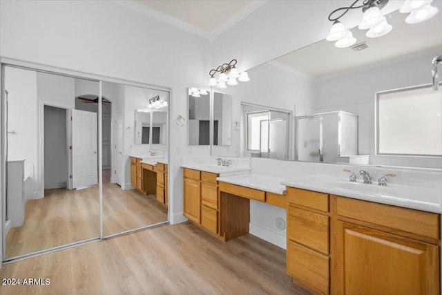 bathroom featuring wood-type flooring, vanity, walk in shower, and crown molding