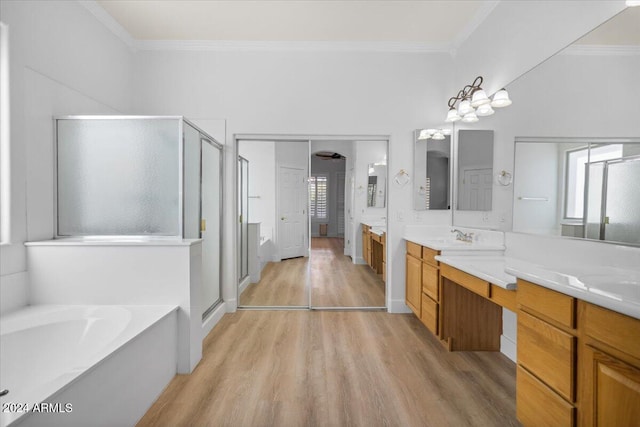 bathroom with shower with separate bathtub, wood-type flooring, and crown molding