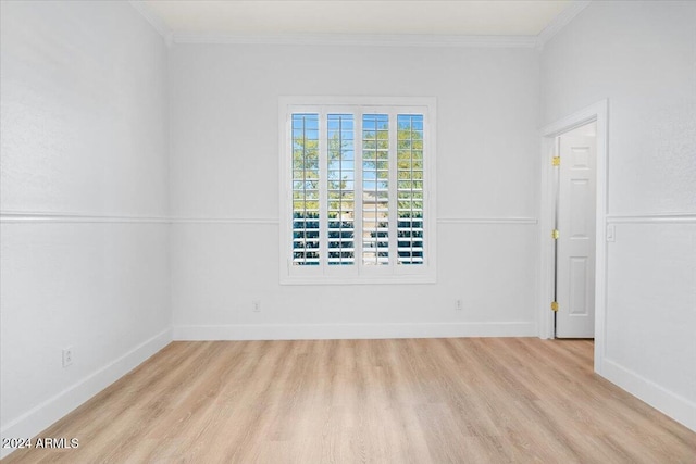 spare room with light hardwood / wood-style flooring and ornamental molding