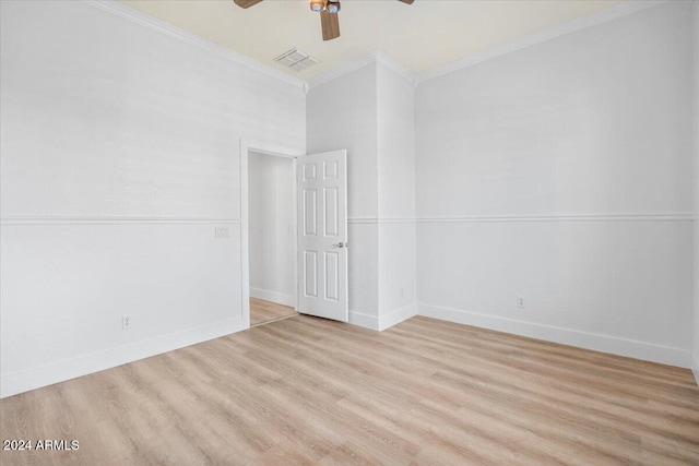 empty room with ceiling fan, crown molding, and light hardwood / wood-style flooring