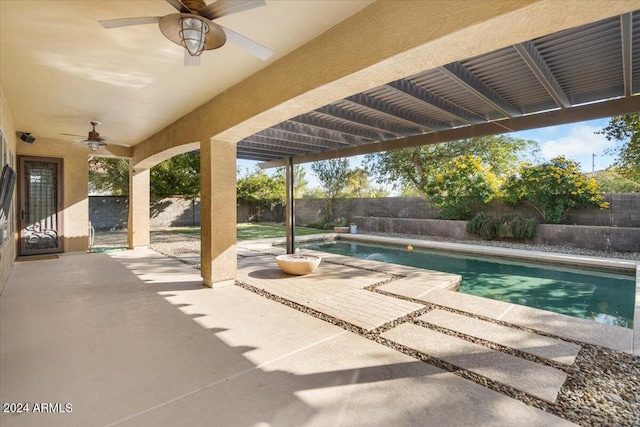 view of swimming pool with ceiling fan and a patio area