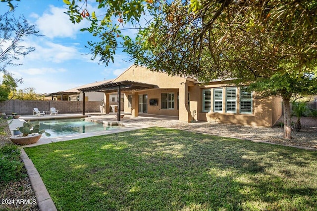 rear view of house featuring a patio, a fenced in pool, a pergola, and a lawn