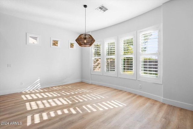 empty room with light hardwood / wood-style flooring