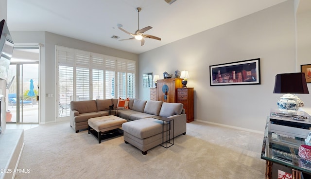 carpeted living room with ceiling fan