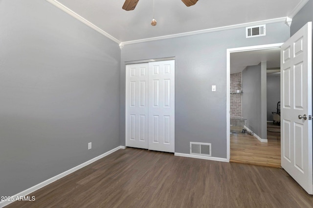 4304 W Calle Poco, Laveen, AZ 85339 - unfurnished bedroom featuring crown molding, dark wood-style floors, baseboards, a closet, and ceiling fan