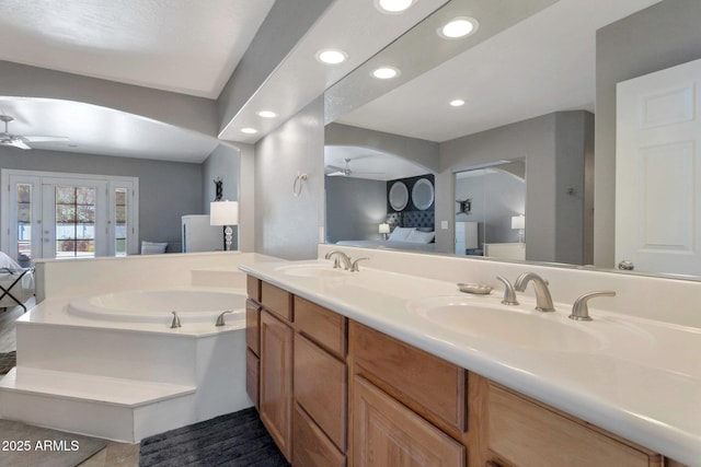 4304 W Calle Poco, Laveen, AZ 85339 - ensuite bathroom featuring ceiling fan, a bath, double vanity, and recessed lighting