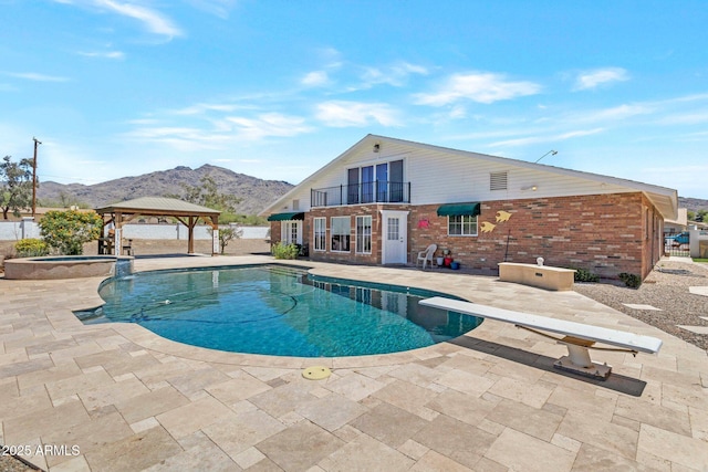 4304 W Calle Poco, Laveen, AZ 85339 - view of swimming pool with a gazebo, a patio area, a mountain view, a pool with connected hot tub, and a diving board