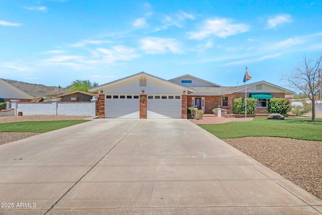4304 W Calle Poco, Laveen, AZ 85339 - ranch-style house with an attached garage, driveway, and brick siding