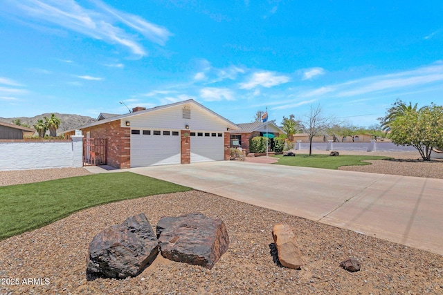 4304 W Calle Poco, Laveen, AZ 85339 - ranch-style home with driveway, a garage, brick siding, and a gate