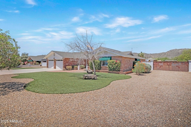 4304 W Calle Poco, Laveen, AZ 85339 - ranch-style house with a gate, driveway, a garage, brick siding, and a mountain view