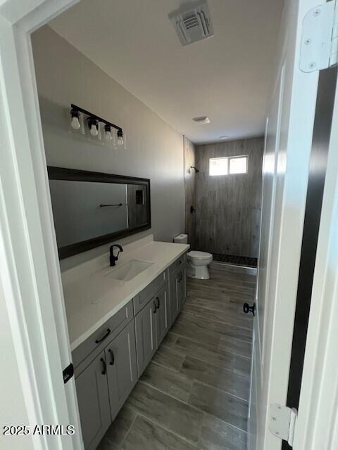 bathroom featuring hardwood / wood-style floors and double vanity