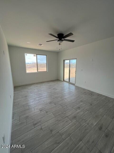 empty room featuring light hardwood / wood-style flooring and ceiling fan