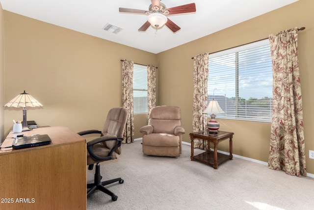 carpeted office with a ceiling fan, baseboards, and visible vents