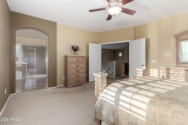 bedroom with a ceiling fan, visible vents, arched walkways, baseboards, and carpet