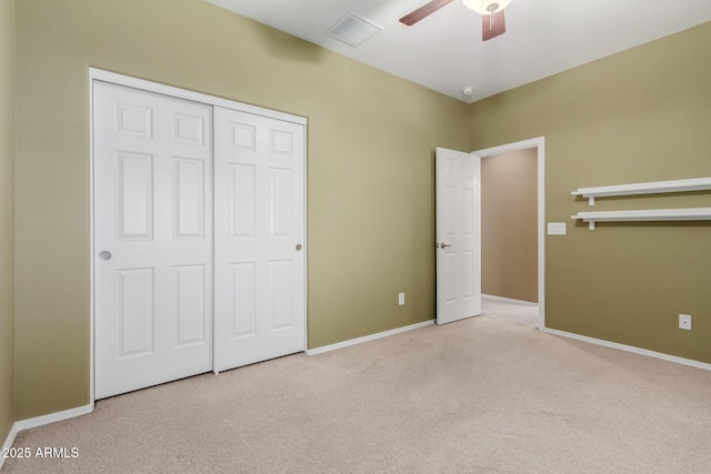 unfurnished bedroom featuring carpet floors, baseboards, a closet, and visible vents