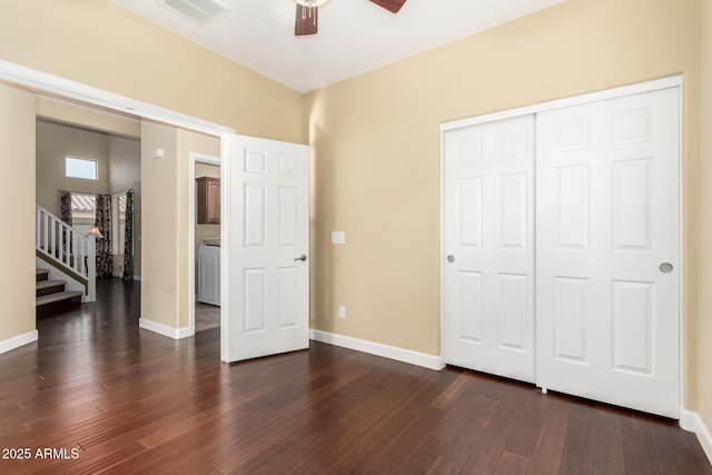 unfurnished bedroom with a closet, baseboards, visible vents, and dark wood-type flooring