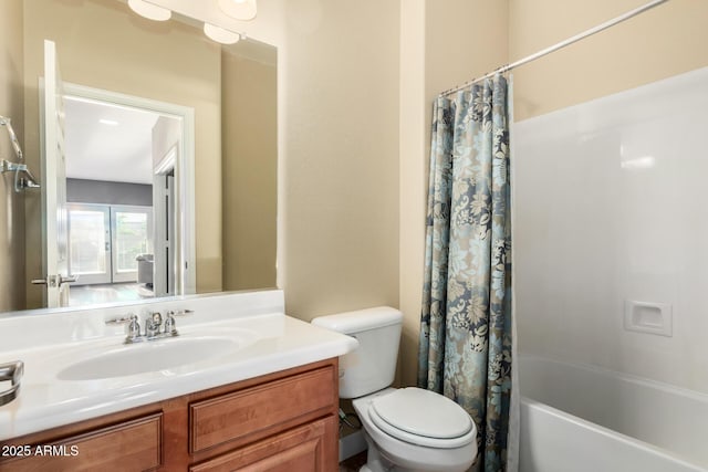full bathroom featuring vanity, shower / bath combination with curtain, and toilet