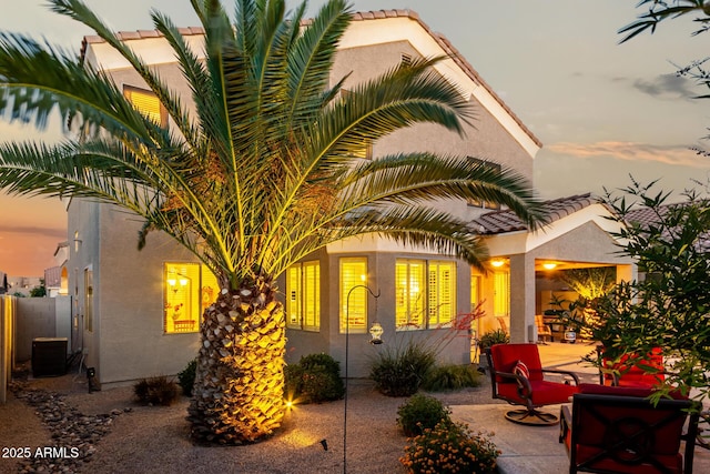 patio terrace at dusk with fence and central AC