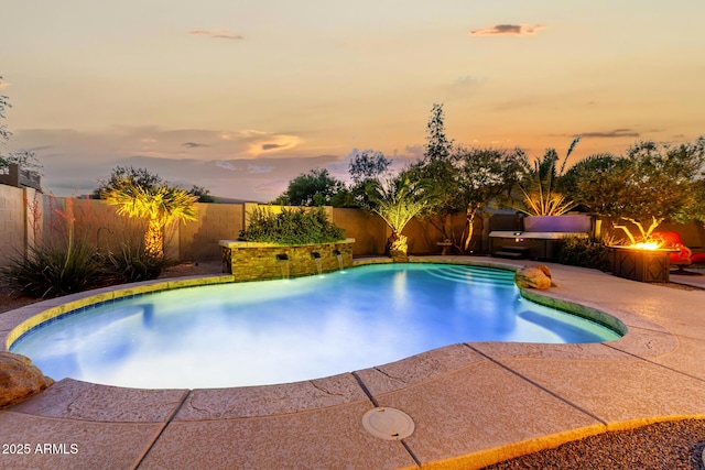 pool at dusk featuring a fenced in pool, a fire pit, a fenced backyard, and a patio area