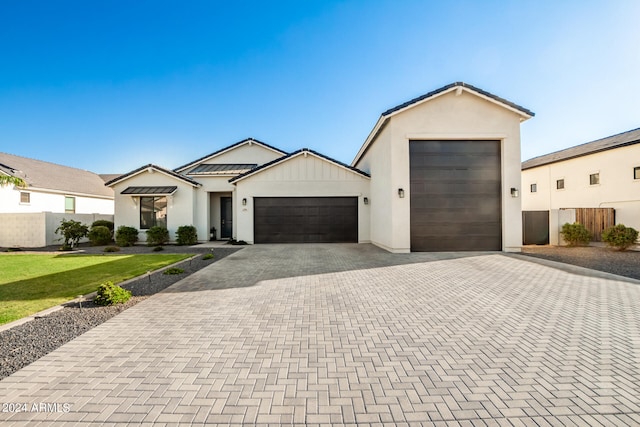 view of front of house with a garage and a front lawn