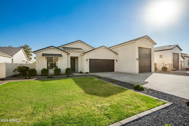 view of front of home featuring a garage and a front yard