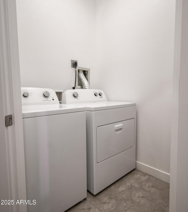 clothes washing area featuring washer and clothes dryer