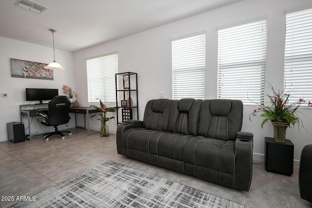 living room featuring light tile patterned floors and a healthy amount of sunlight