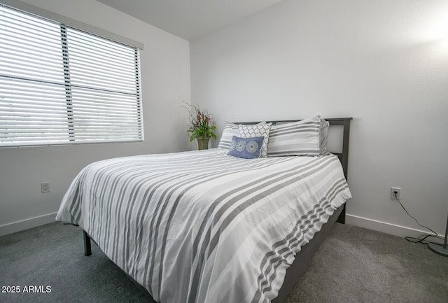 bedroom with lofted ceiling and dark colored carpet