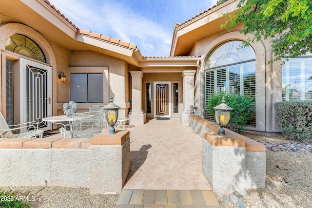 property entrance featuring a patio area