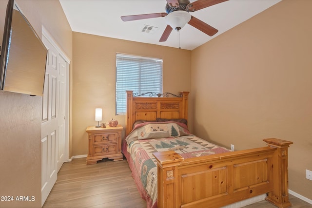 bedroom featuring ceiling fan, visible vents, baseboards, a closet, and light wood-type flooring