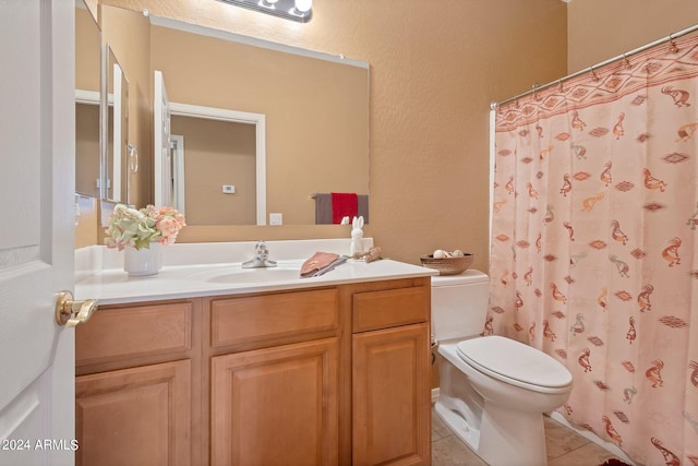 bathroom with a shower with curtain, a textured wall, toilet, vanity, and tile patterned flooring