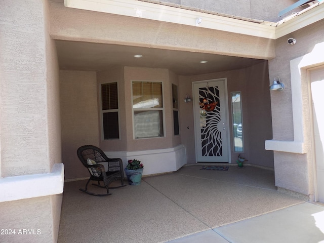 view of exterior entry featuring stucco siding