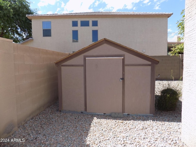 view of shed featuring fence