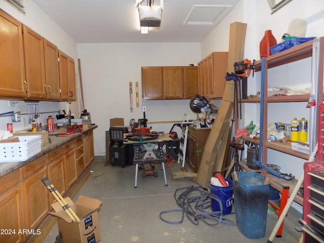 garage with a workshop area and a garage door opener