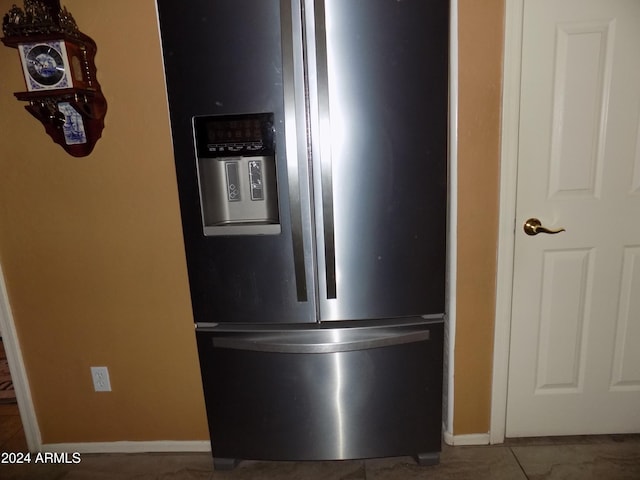 details featuring stainless steel fridge and baseboards