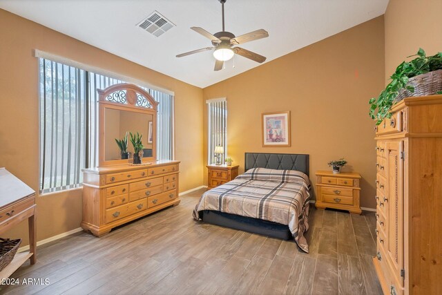 bedroom with hardwood / wood-style flooring, lofted ceiling, and ceiling fan