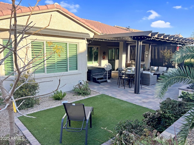 rear view of house with a yard, an outdoor hangout area, and a patio