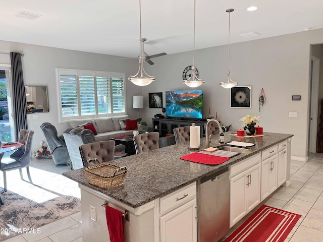 kitchen featuring sink, white cabinetry, hanging light fixtures, an island with sink, and stainless steel dishwasher