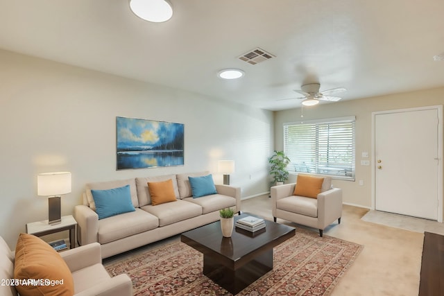 carpeted living room with ceiling fan