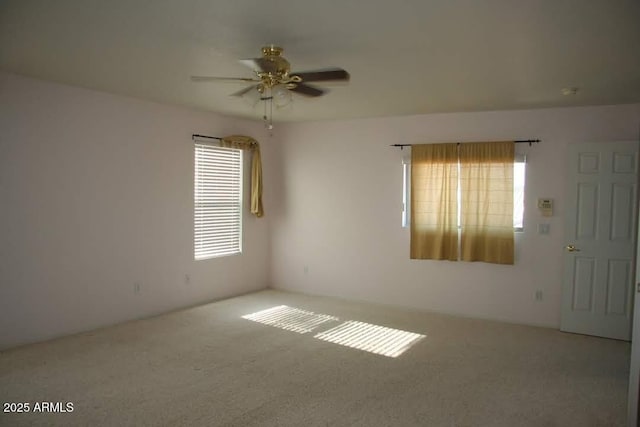 empty room featuring carpet and ceiling fan