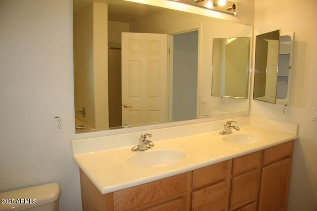 full bath featuring double vanity, toilet, and a sink